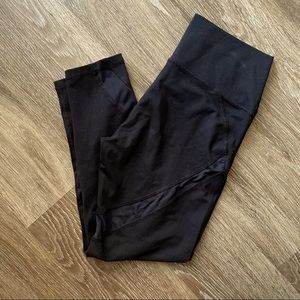 Black athletic leggings with mesh cutouts